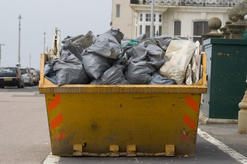 Construction site with waste materials being cleared by professionals